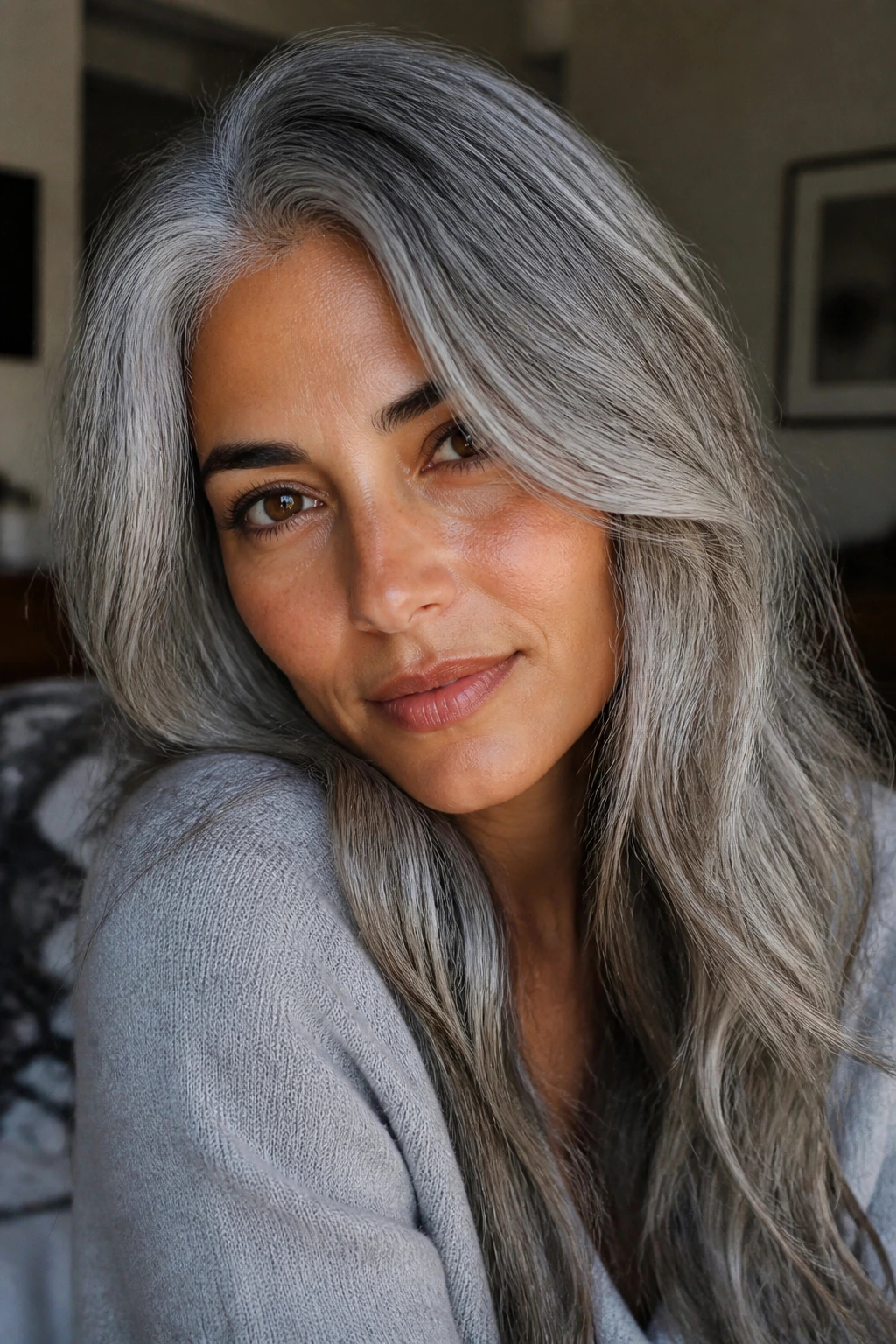Portrait of person with soft silver hair on olive skin in natural light.