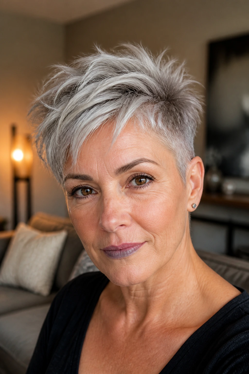 Close-up of a real woman with soft undercut pixie hairstyle showing longer top.