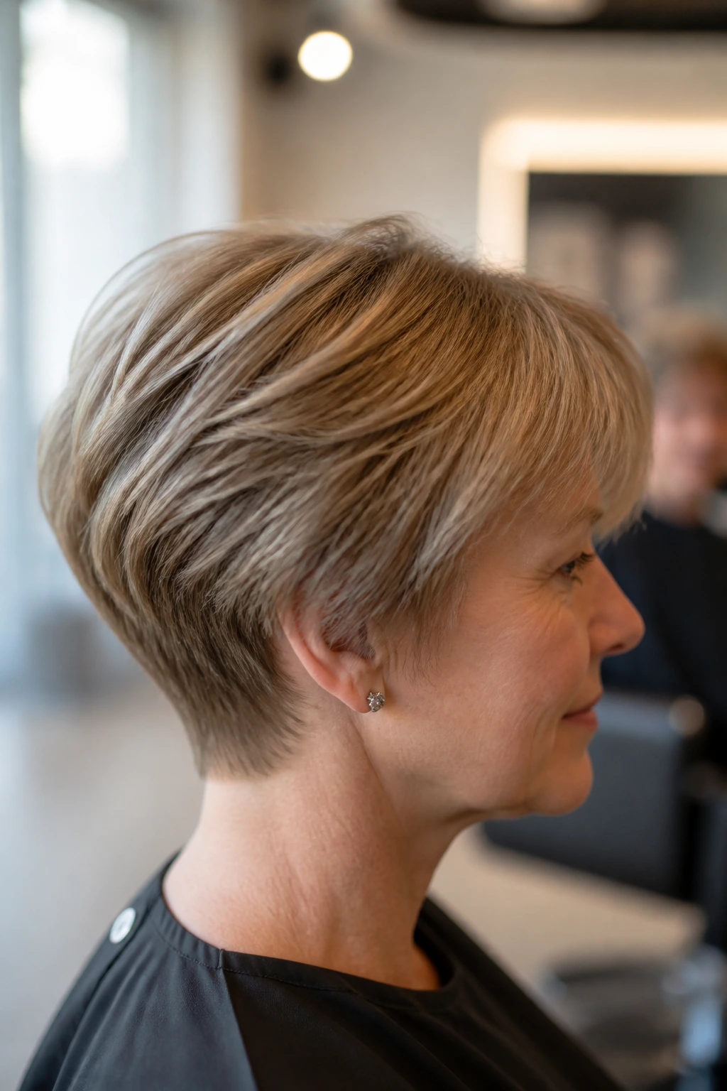 Close-up side profile of a real woman with soft wedge cut showing rounded crown