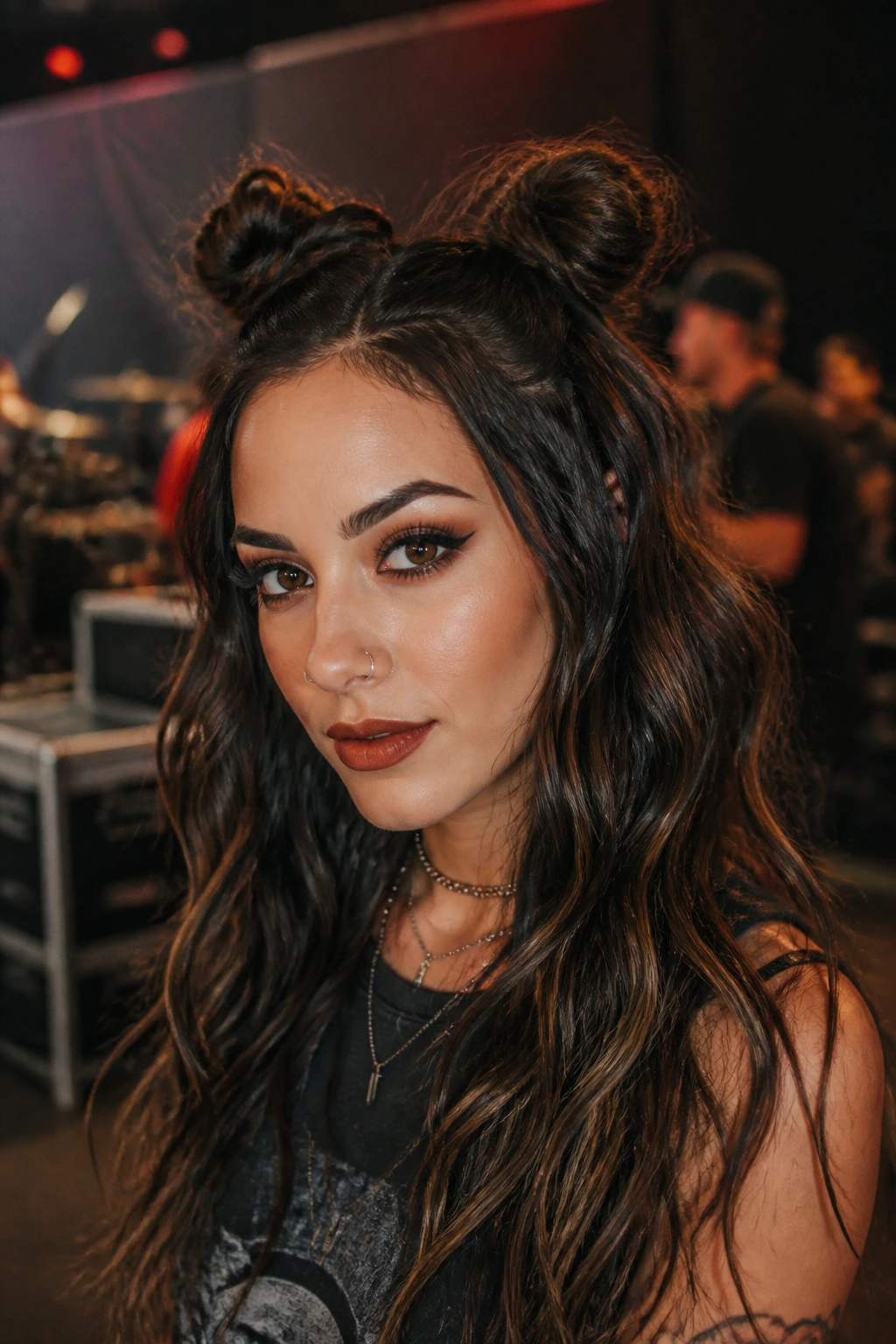 Real woman with space buns and loose waves backstage at a concert