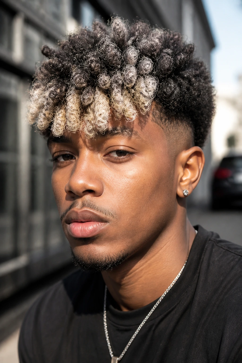 Close-up portrait of a real Black man with sponge curls and an ice-blond fringe