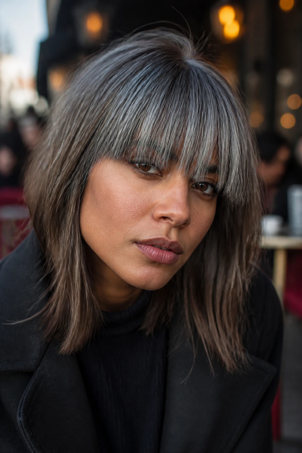 Portrait of person with steel-gray fringe.