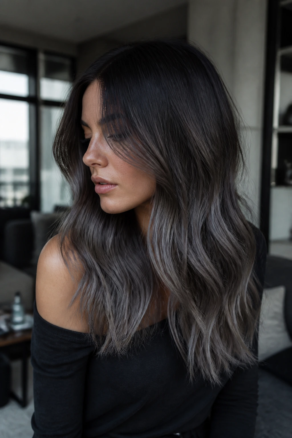 Close-up of a real woman with steel-toned sombre balayage from roots to ends.