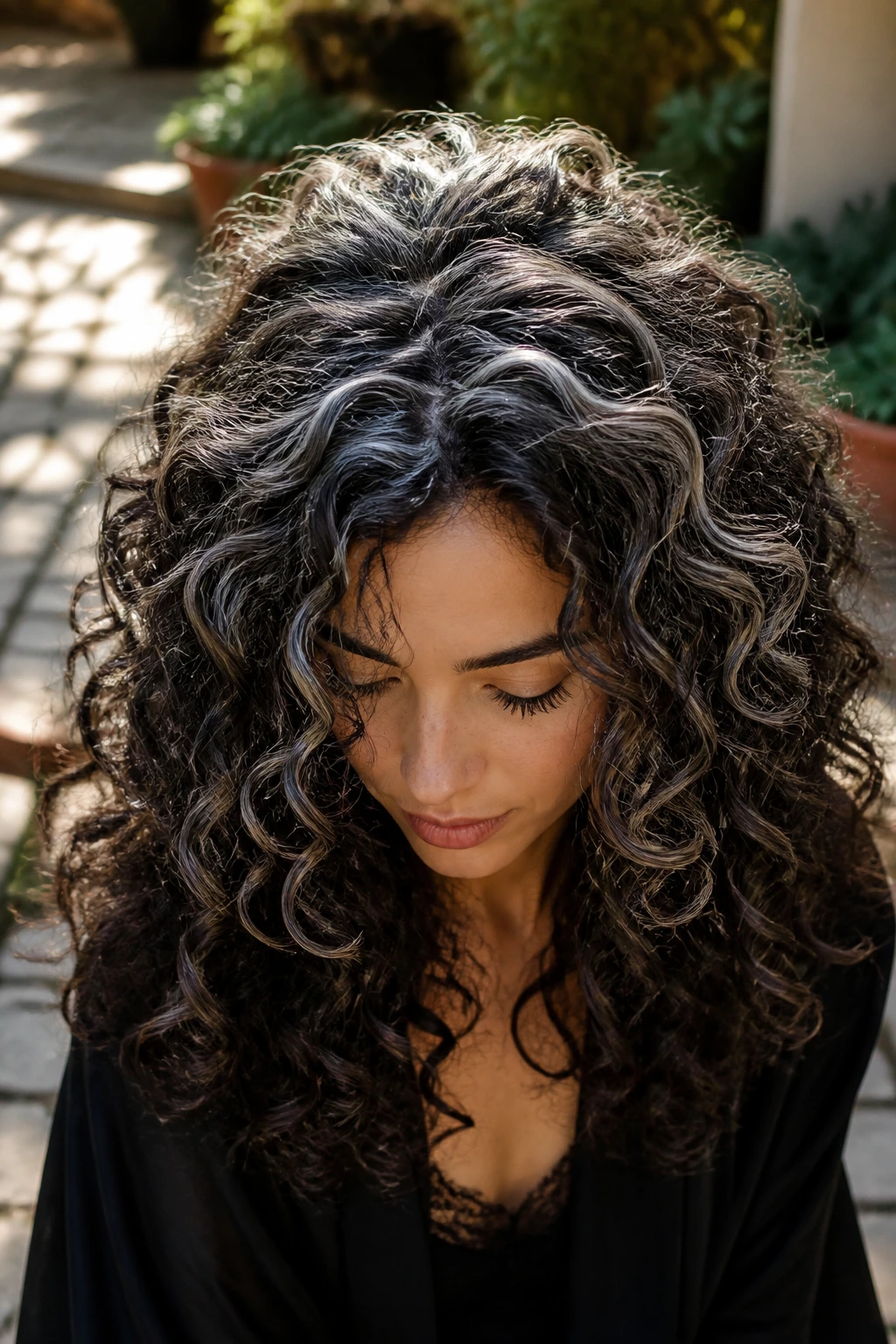 Portrait of brunette with crown halo lights on top curls in outdoor daylight