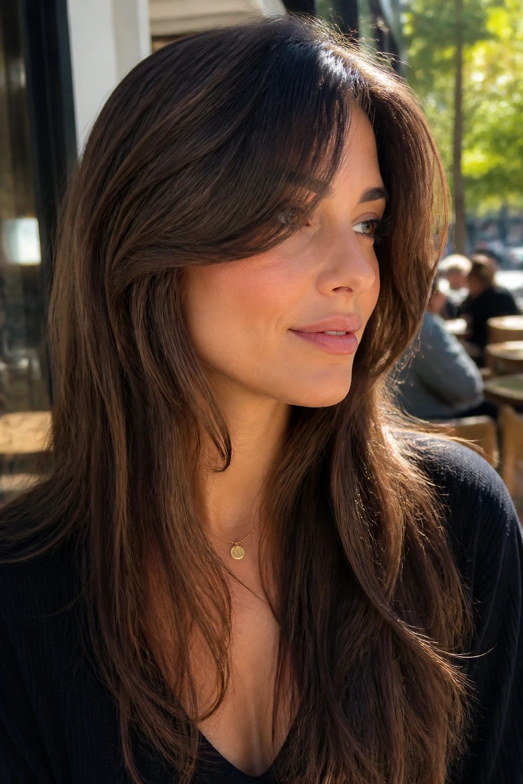 Close-up portrait of temple-start bangs blending into long layers for a seamless front frame.