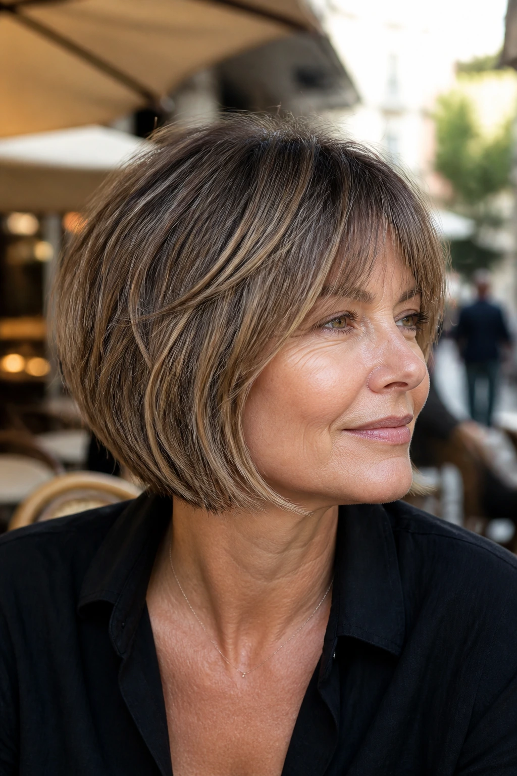 Close-up of a real woman with a textured bob and micro layers near the crown