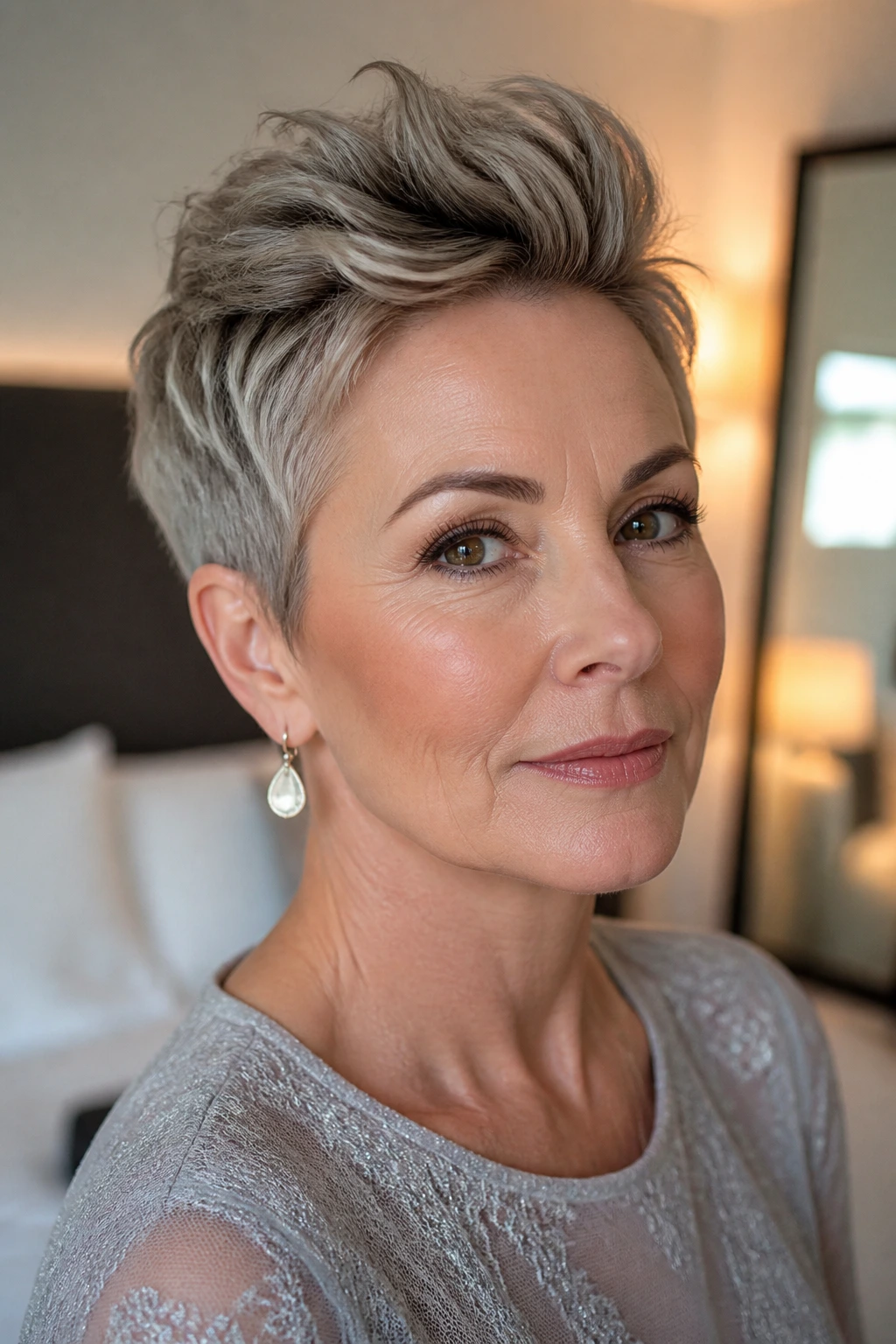 Close-up of a real woman with a textured pixie and lifted front hairstyle.
