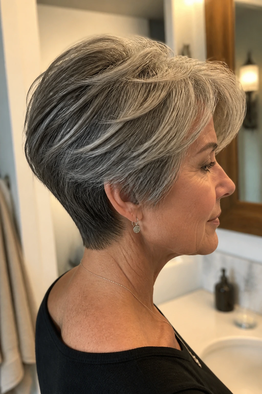 Medium close-up of a real woman with thick hair showing interior layering and tapered perimeter