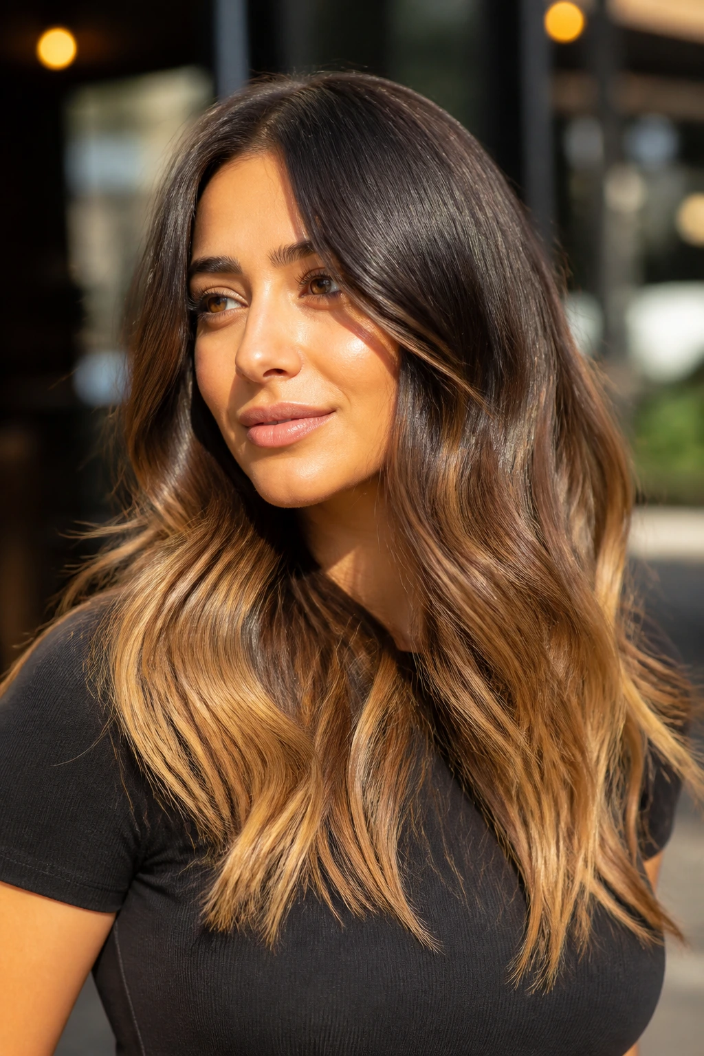 Close-up of toasted almond ends on dark hair with sunlit background