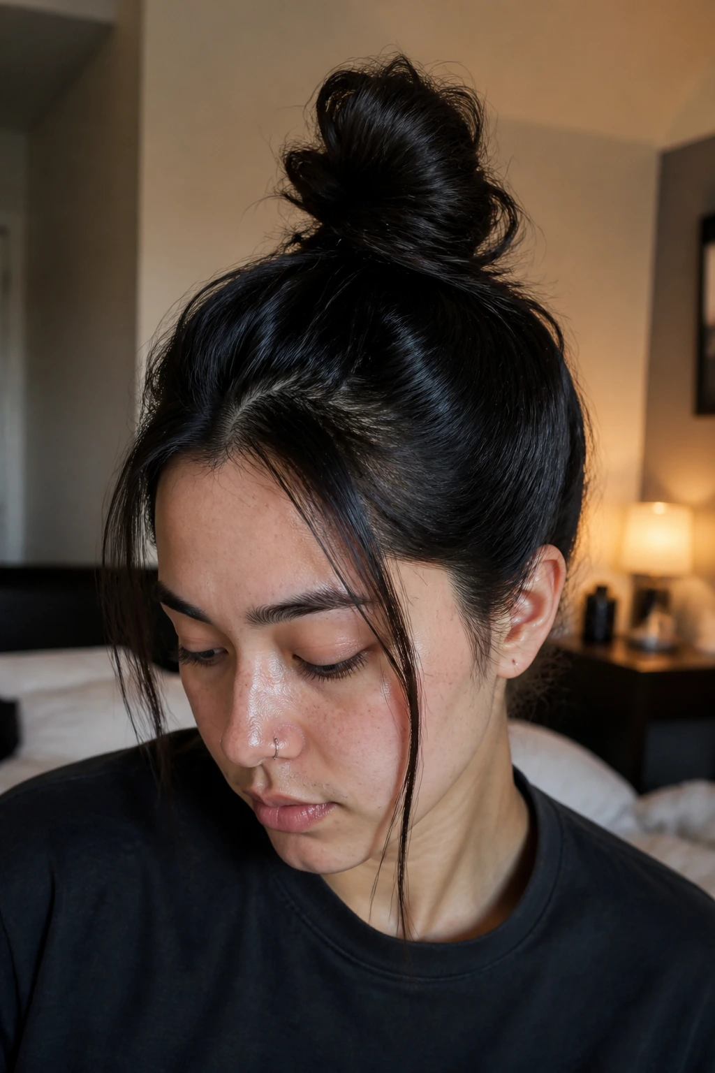 Close-up of a real person with a top knot and face-framing pieces