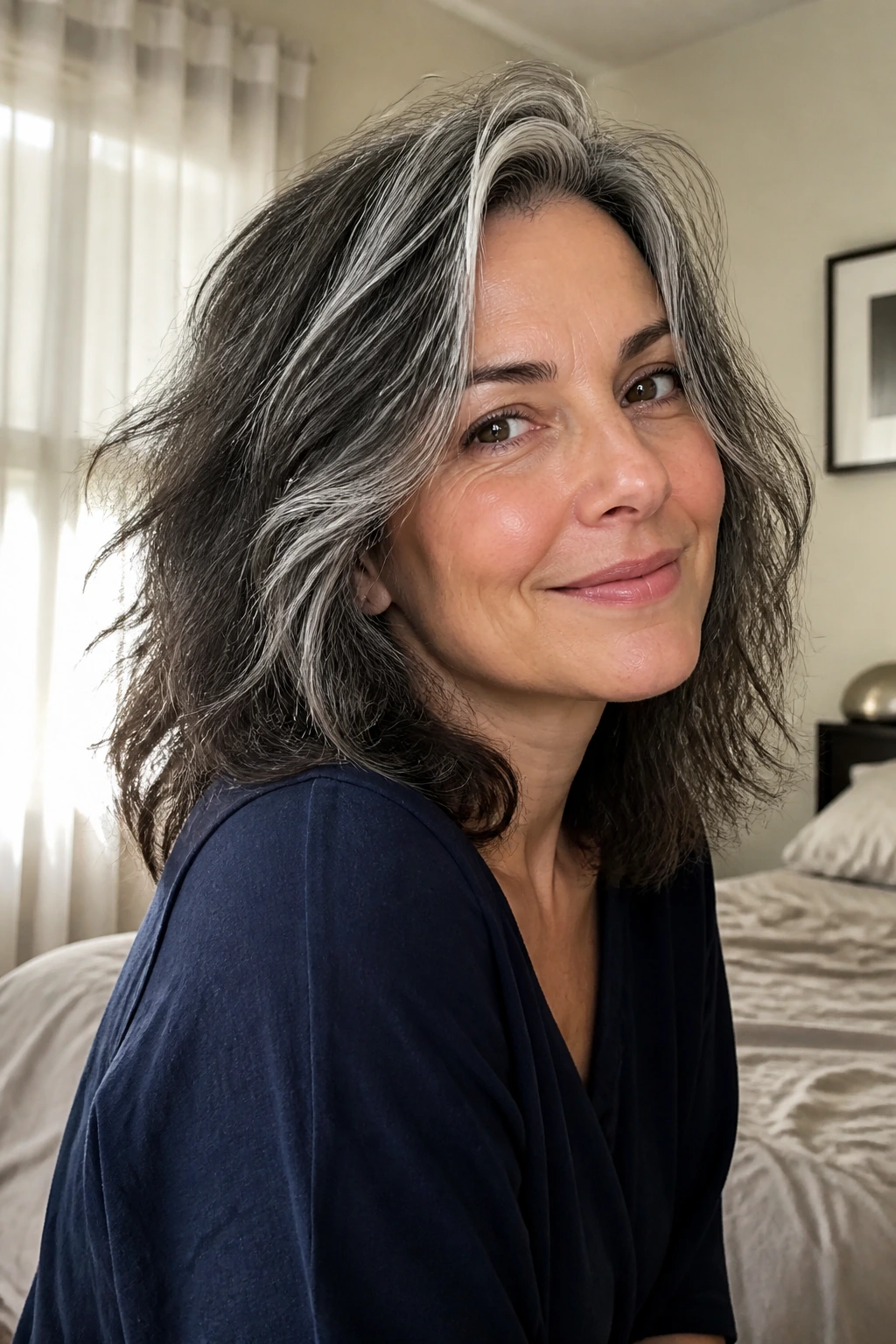 Close-up of a real woman with tousled shoulder-length hair and air-dried texture