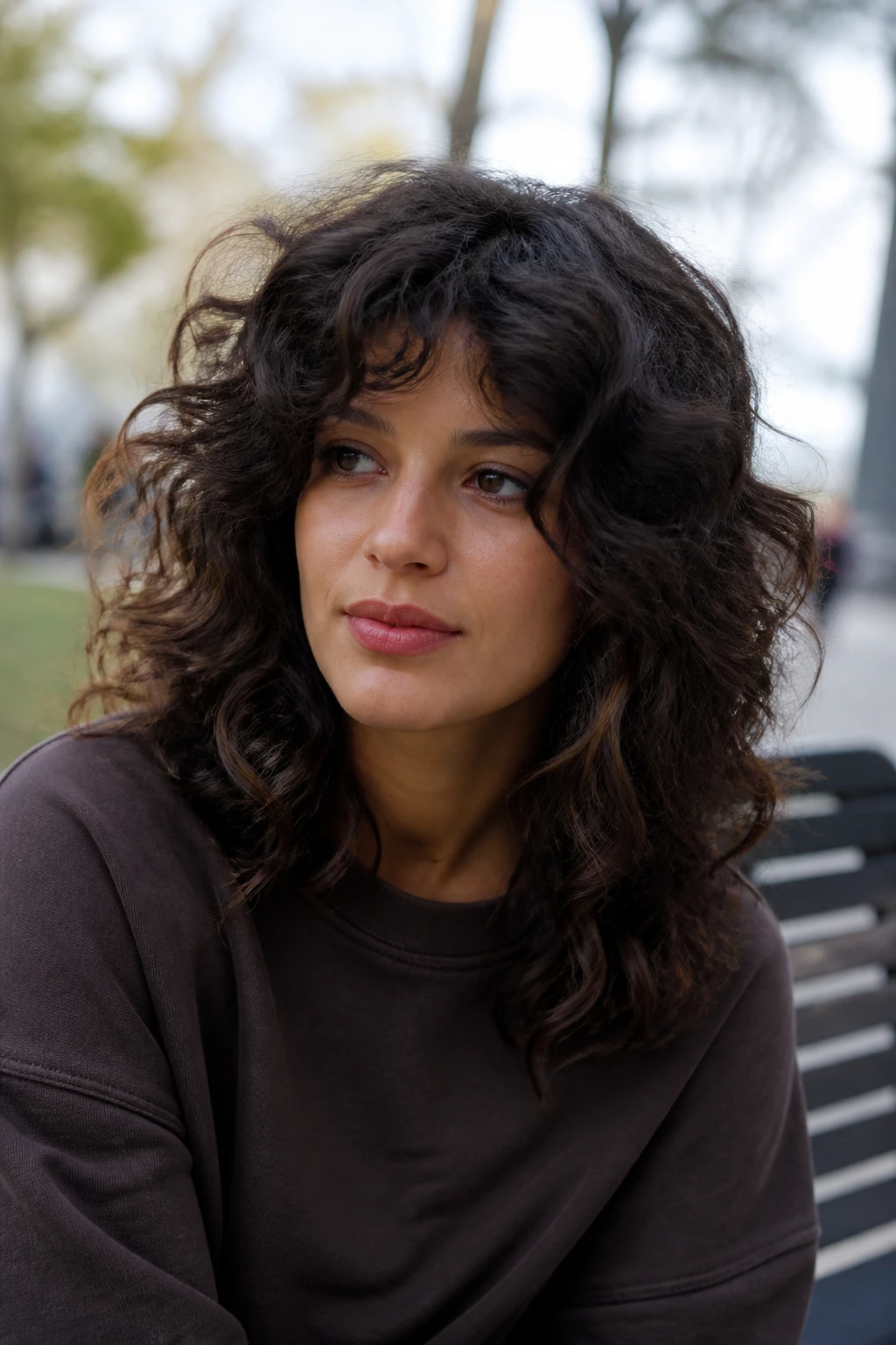 Close-up portrait of a real person with triangle-resistant layered curls