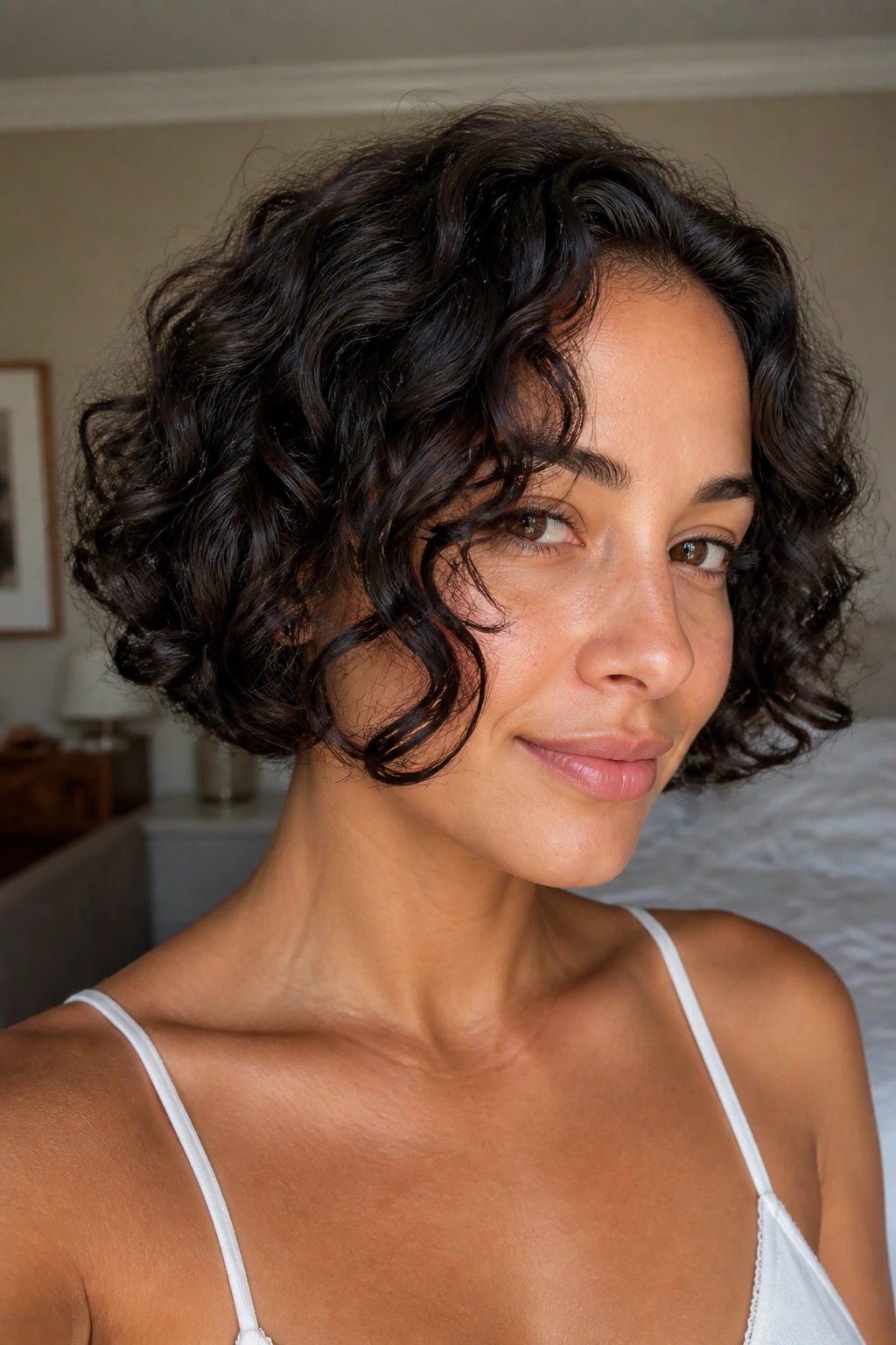Close-up of a real woman with a tucked faux bob hairstyle, nape tuck and front curls framing the chin.