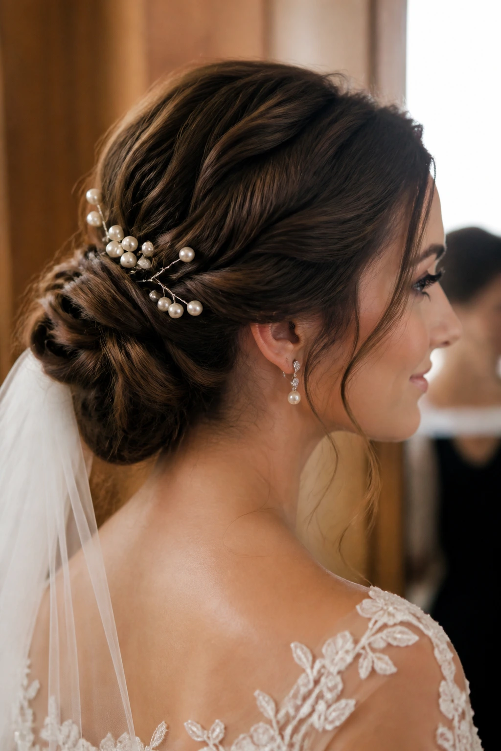 Close-up of Twisted Low Bun with Pearl Pins on a real bride