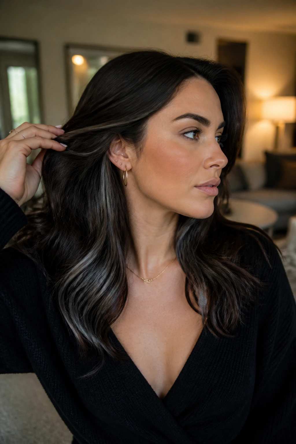 Portrait showing dark brunette hair with discreet cool underlights at the nape and behind the ears.