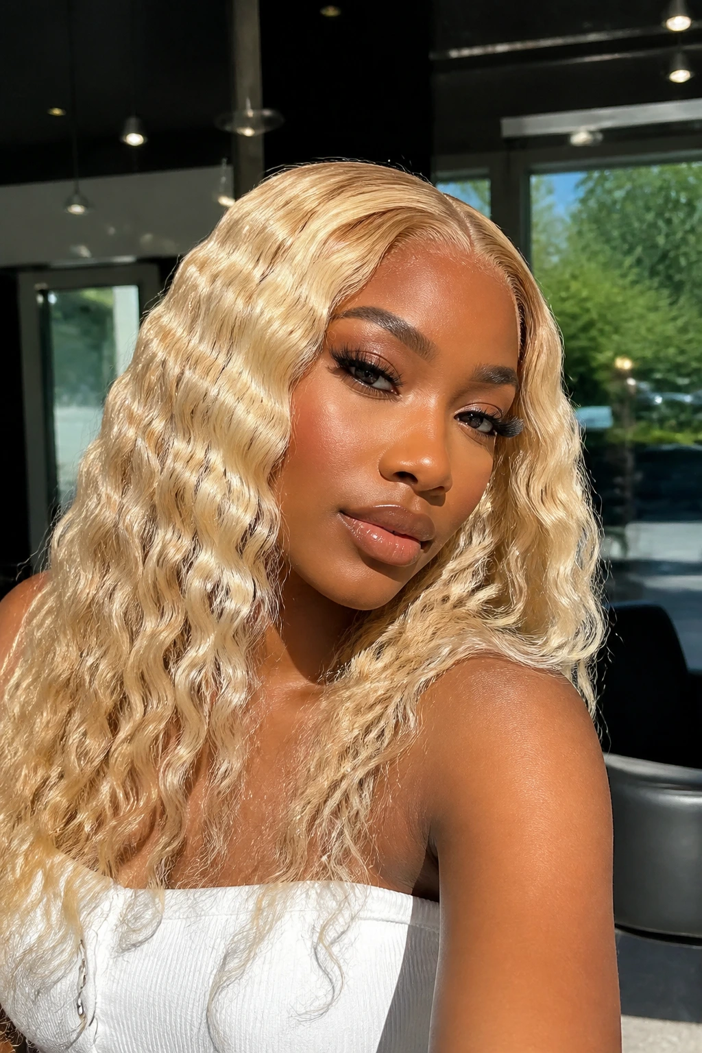 Close-up of a real person with vanilla blonde water wave install.