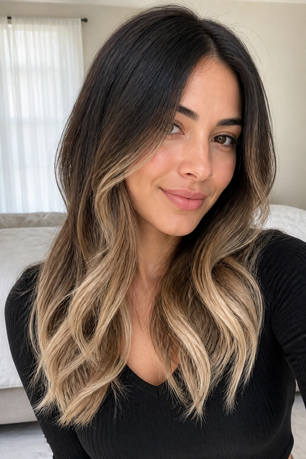 Close-up of a real woman with dark hair fading to vanilla cream ends