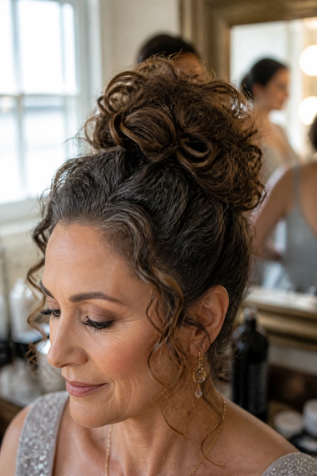 Close-up of a real woman with voluminous top knot curls