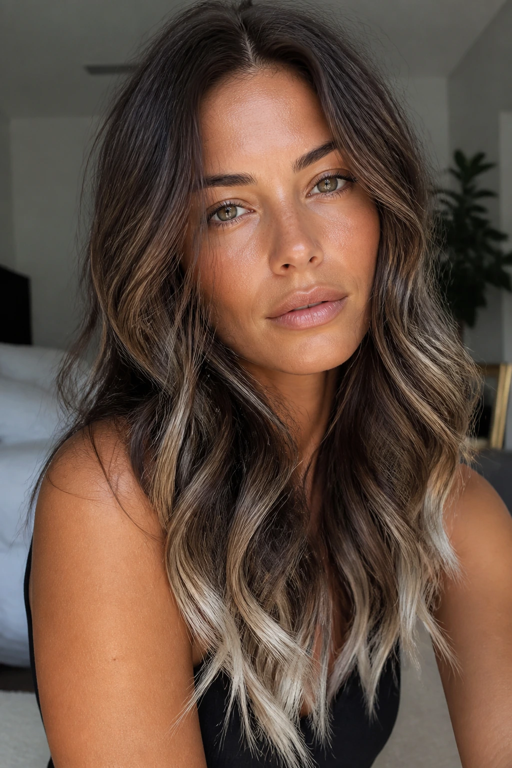 Close-up portrait of woman with walnut brunette hair and icy tips.