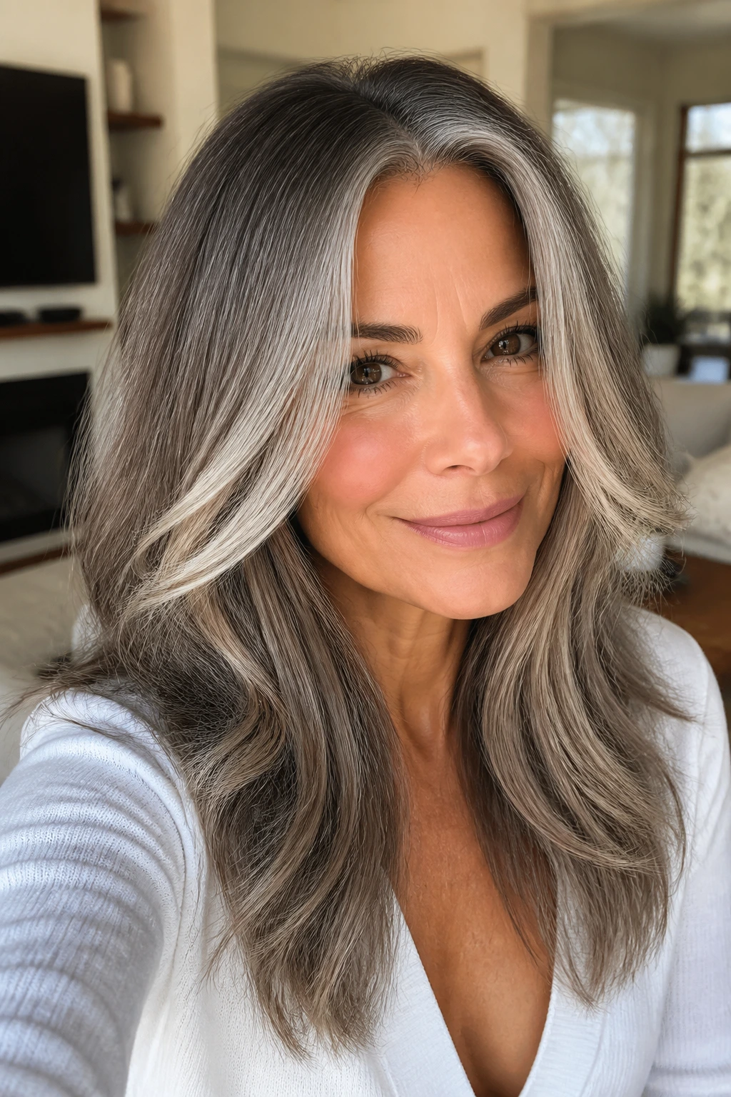 Close-up of a real woman with warm ash ombré face frames