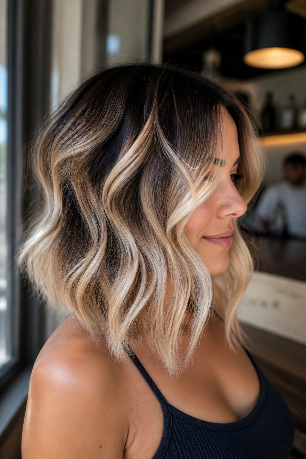 Real woman with a wavy lob showing ribboned brightness highlights