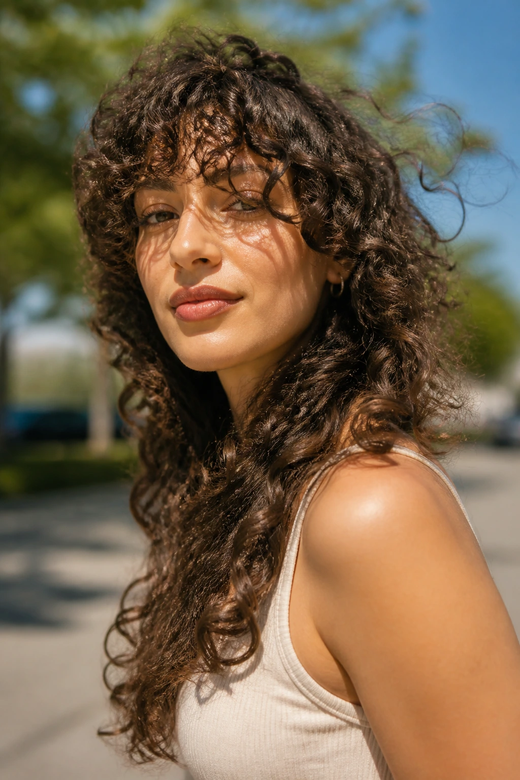 Wind-swept curly shag portrait showing dynamic face-framing shape