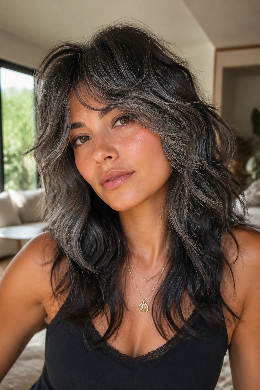 Close-up of a real woman with a Wavy Wolf Cut With Charcoal Transition on tan skin