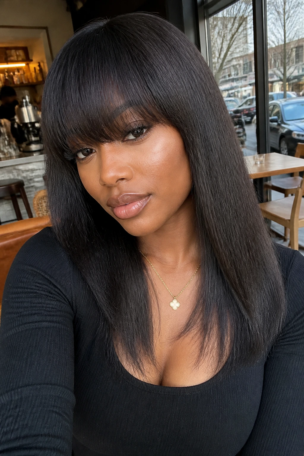 Real person with yaki-straight hair and arched bangs in a cafe setting