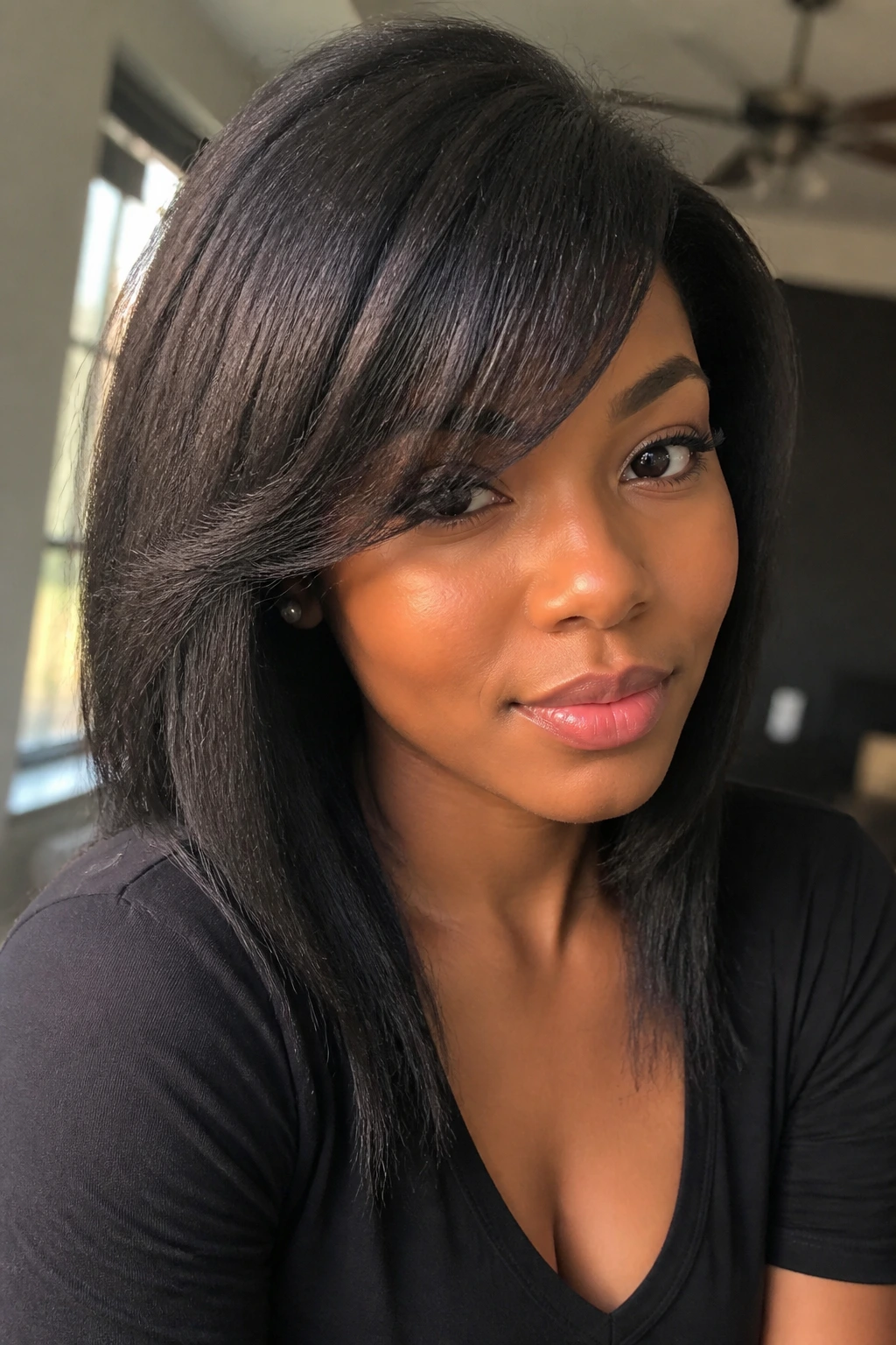 Close-up portrait of a real Black woman with yaki textured blowout and side fringe